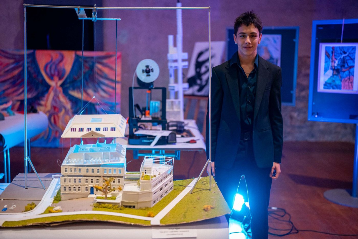 Ariya Man beside his moving architectural model